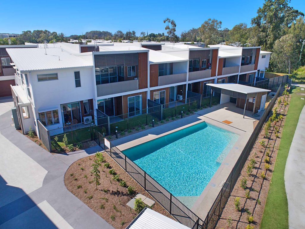 Overview of the dual key rooming development with swimming pool in the foreground.